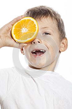 Little cute boy with orange fruit double isolated on white smiling without front teeth adorable kid cheerful