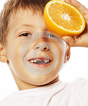 Little cute boy with orange fruit double isolated on white smiling without front teeth adorable kid cheerful