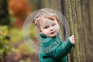 Little cute boy in the park. Close up picture of Lovelyl ittle boy in the autumn garden. Outdoor activities for children