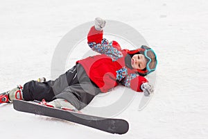 Little cute boy with skis and a ski outfit. Little skier in the