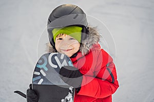 Little cute boy snowboarding. Activities for children in winter. Children`s winter sport. Lifestyle