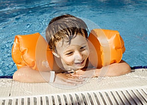 Little cute boy in swimming pool
