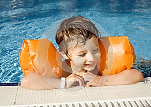 Little cute boy in swimming pool