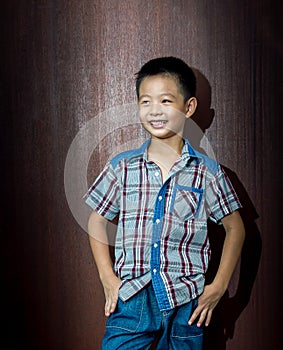 Little cute boy on wood background