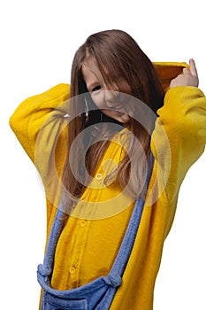 Little cute cheerful girl 10 years old posing in yellow pajamas. Studio photo