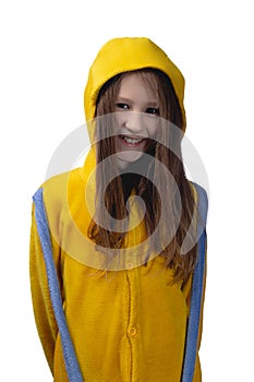 Little cute cheerful girl 10 years old posing in yellow pajamas. Studio photo