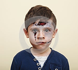 little cute child with facepaint on birthday party, zombie Apocalypse facepainting, halloween preparing concept