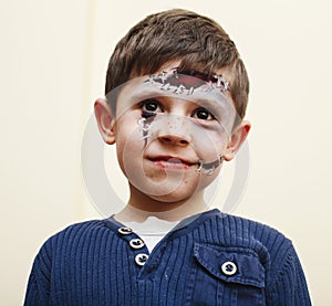 little cute child with facepaint on birthday party, zombie Apocalypse facepainting, halloween preparing concept