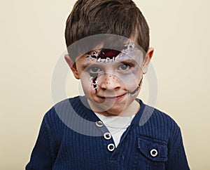 little cute child with facepaint on birthday party, zombie Apocalypse facepainting, halloween preparing concept