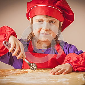 Little cute child girl chef preparing the dough, bake cookie. Food and Ñooking process concept