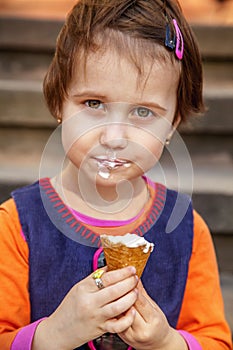 Little cute child girl eating ice cream. Food, dessert, happy childhood, carelessness concept