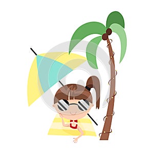 Little cute child girl lying and sunbathing on beach towel. Hides from the sun under palm trees and umbrella