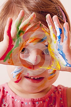 Little cute child girl showing painted hands