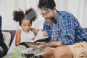 Little cute child looking amaze love to reading book and learn support from dad to smart kid concept