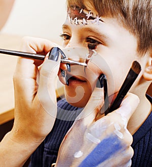 Little cute child making facepaint on birthday party, zombie Apo