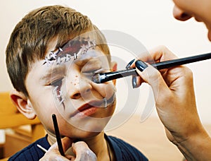 Little cute child making facepaint on birthday party, zombie Apo