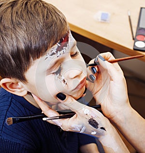 Little cute child making facepaint on birthday party, zombie Apo