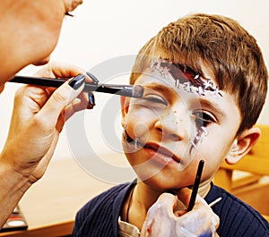 Little cute child making facepaint on birthday party, zombie Apo