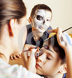 Little cute child making facepaint on birthday party, zombie Apo