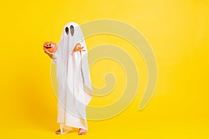 Little cute child with white dressed costume halloween ghost scary he holding orange pumpkin ghost on hand