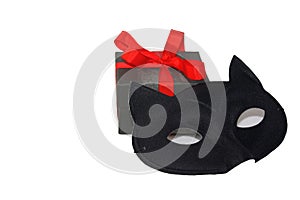 Little cute gift box with bright red ribbon and mysterious eye cat mask, isolated on white background