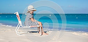 Little cute girl in beach chair relax on caribbean