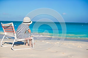 Little cute girl in beach chair relax on caribbean