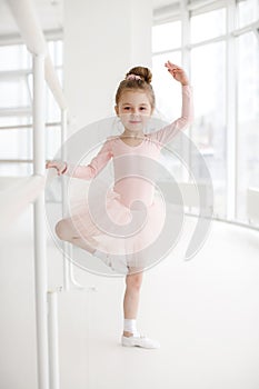 Little cute girl in class in ballet studio