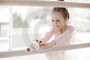 Little cute girl in class in ballet studio