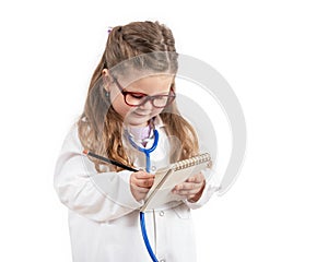 Little cute girl in doctor costume holding sthetoscope on chalkboard.