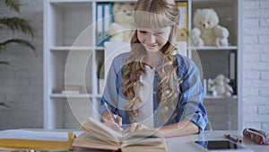 Little cute girl doing homework in her room. children 9-12 years old. 4K