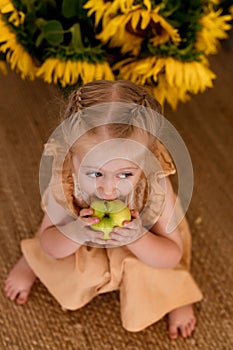 Little cute girl eats an apple. Healthy food concept. Vitamins in natural products