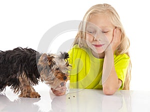 Little cute girl feeding her dog