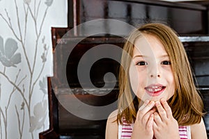 Little cute girl with first lost milk tooth