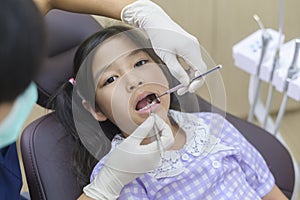 Little cute girl having teeth examined by dentist in dental clinic, teeth check-up and Healthy teeth concept