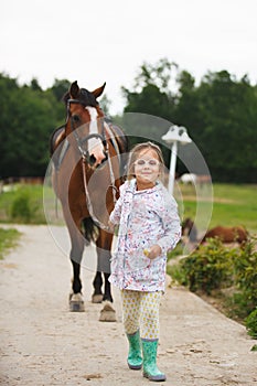 Little cute girl with horse