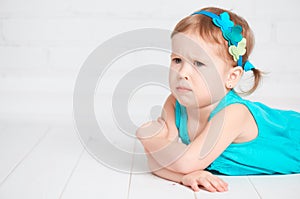 Little cute girl offended, angry frown photo