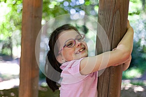 Little girl playing in the playground on a sunny summer day. Outdoor activities for children