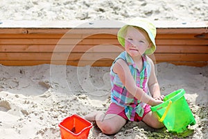 Little cute girl playing in sandbox