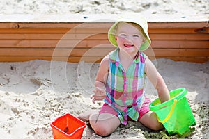 Little cute girl playing in sandbox