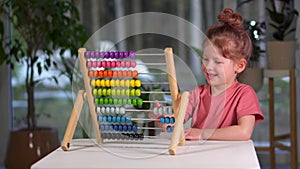 little cute girl plays bills at home. The child is busy playing and learning mathematics. childhood and entertainment