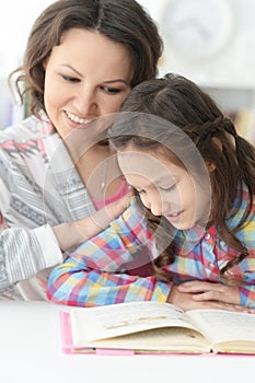 Little cute girl reading book