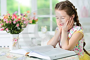 Little cute girl reading book