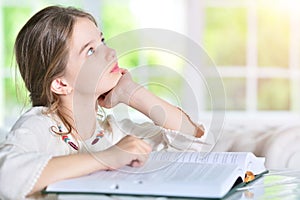 Little cute girl reading book