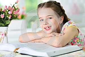 Little cute girl reading book