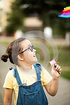 Little cute girl running with kite on summer day in the park outdoor. Summer activity