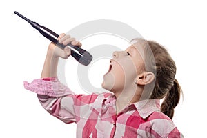 Little cute girl singing into a microphone on a white background