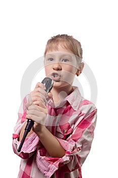 Little cute girl singing into a microphone on a white background