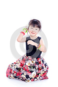 Little cute girl sitting on the floor over white