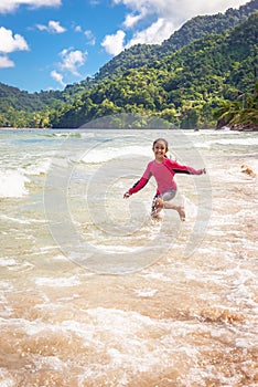 Little cute girl walking in Maracas Bay Beach Trinidad
